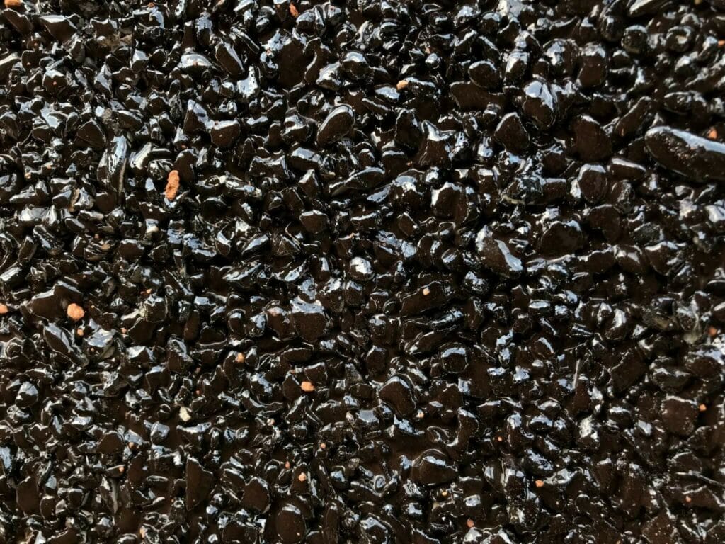 Close-up of a fresh chip seal surface bound with bitumen emulsion